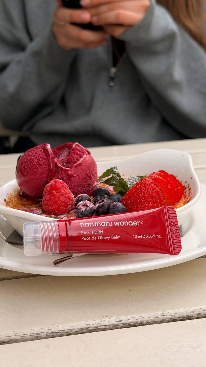 Haruharu Wonder Rose PDRN lip balm on a berry dessert