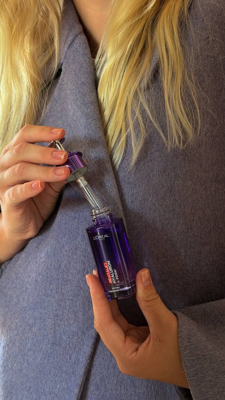 L’Oréal Revitalift Hyaluron & PDRN serum against a lilac coat